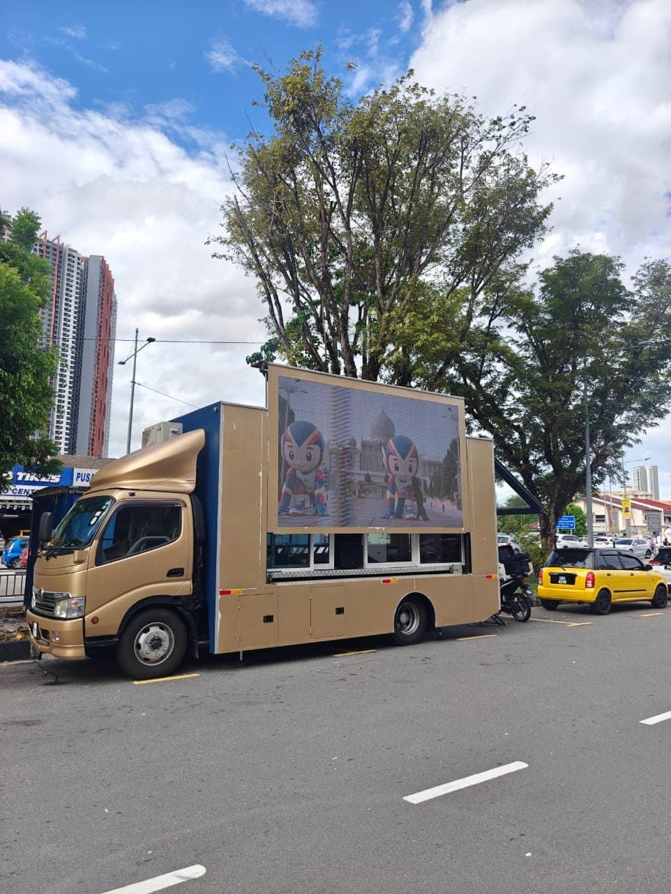 LED truck parked at the kerb in daylight, showing SEA Games mascots