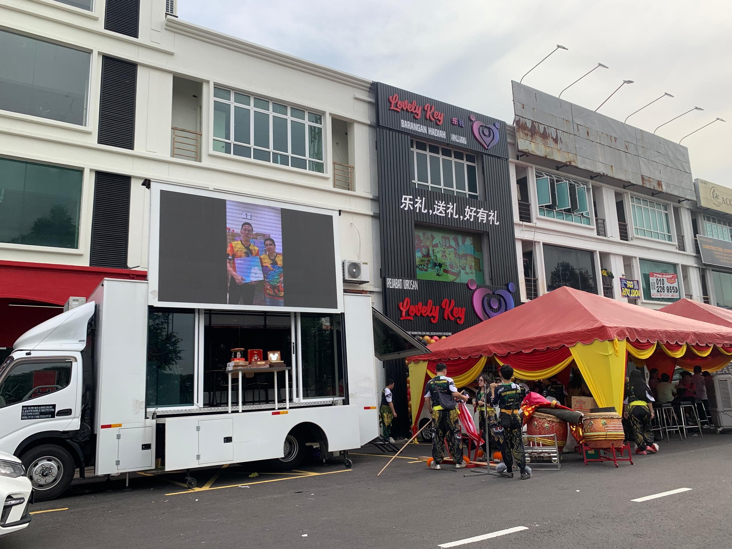 LED truck stationed outside a store during a grand opening